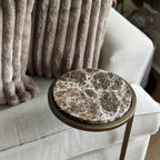 Decorative pillow on a sofa with a marble-patterned side table